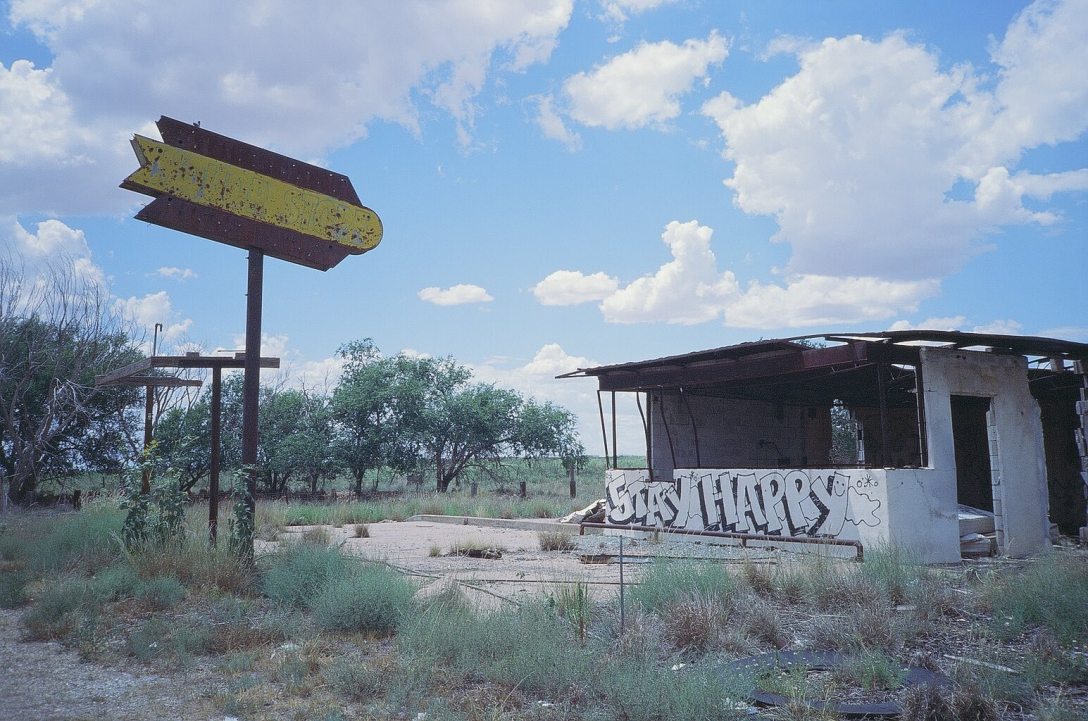 Expired Kodak Elite Chrome 35mm film photograph Burned out liquor store. STAY HAPPY West Texas