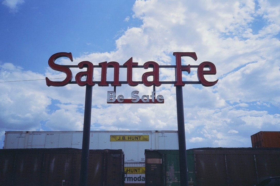 Expired Kodak Elite Chrome 35mm expired film photograph Santa Fe Railyard Sign passing train in Clovis, New Mexico
