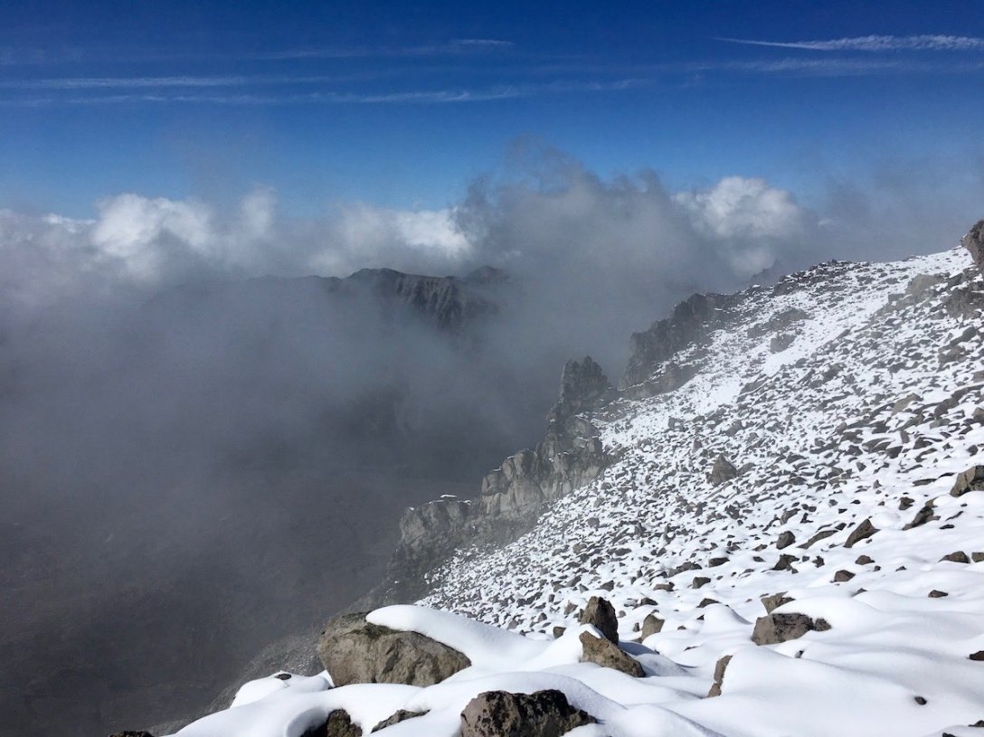 Boulder field atop Third Burroughs, Mount Rainier clouds in the glacial valley below