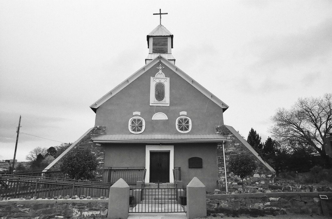 35mm black and white film photograph of Iglesia Nuestra Señora de Los Remedios Church in Galisteo, New Mexico