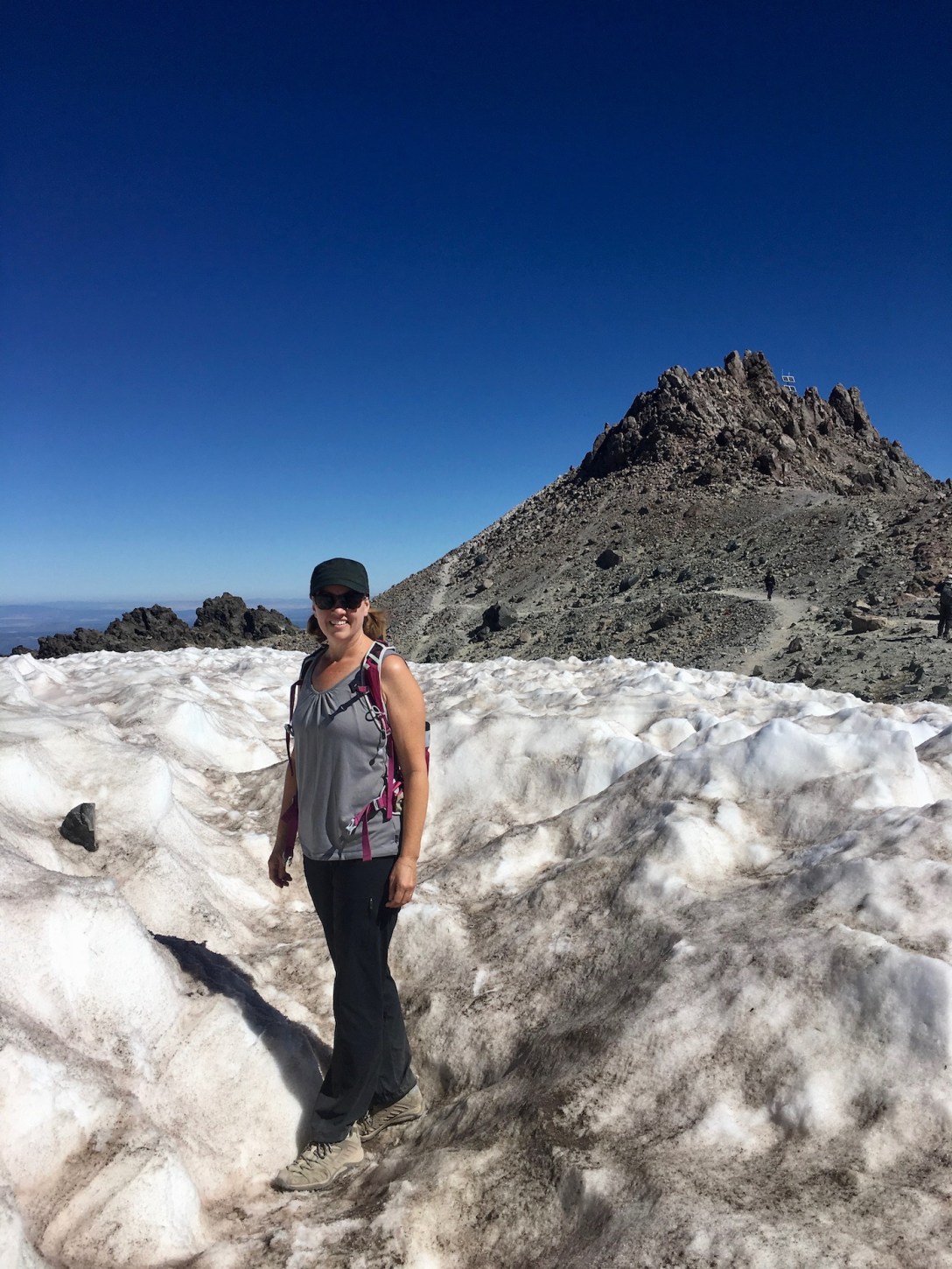 Marsi hiking through permanent snowfield, toward the summit of Lassen Peak in Lassen Volcanic National Park