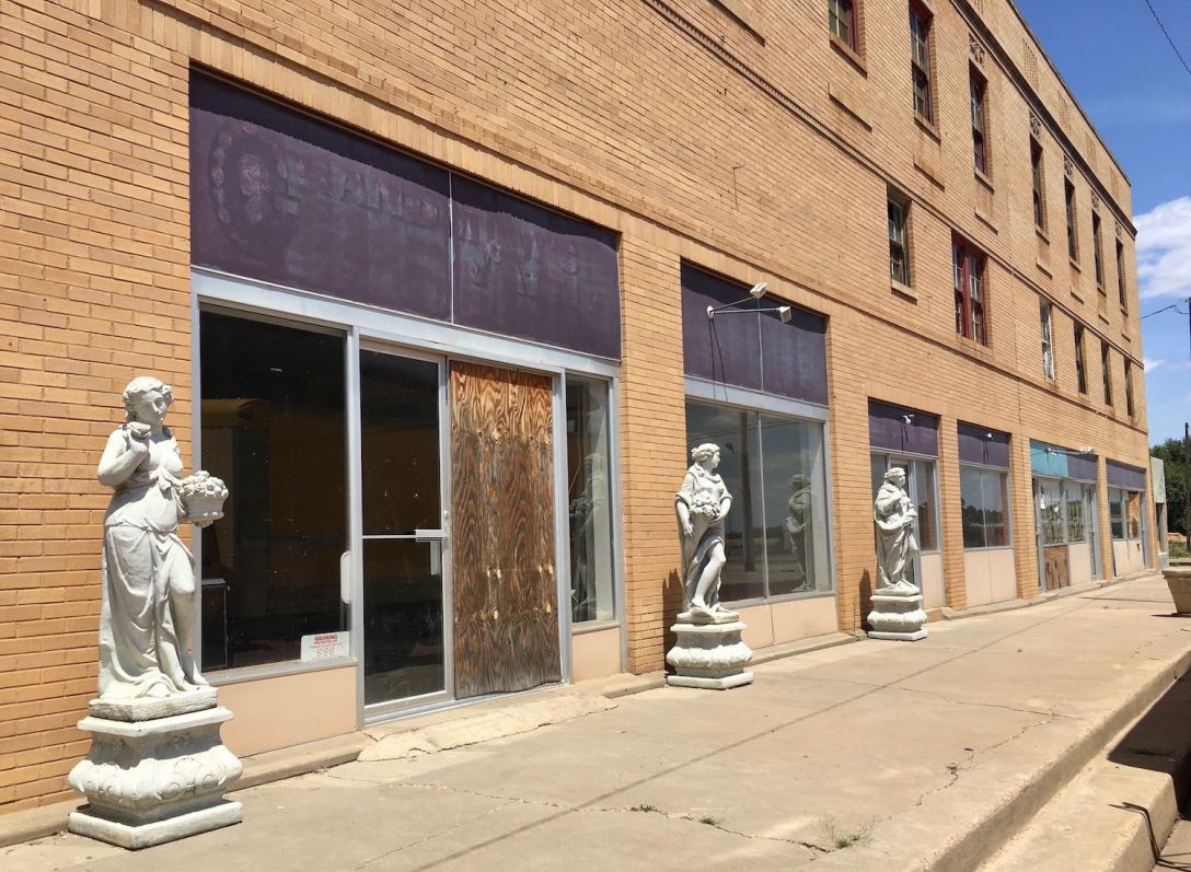 Grecian Statues outside abandoned building in Memphis, Texas