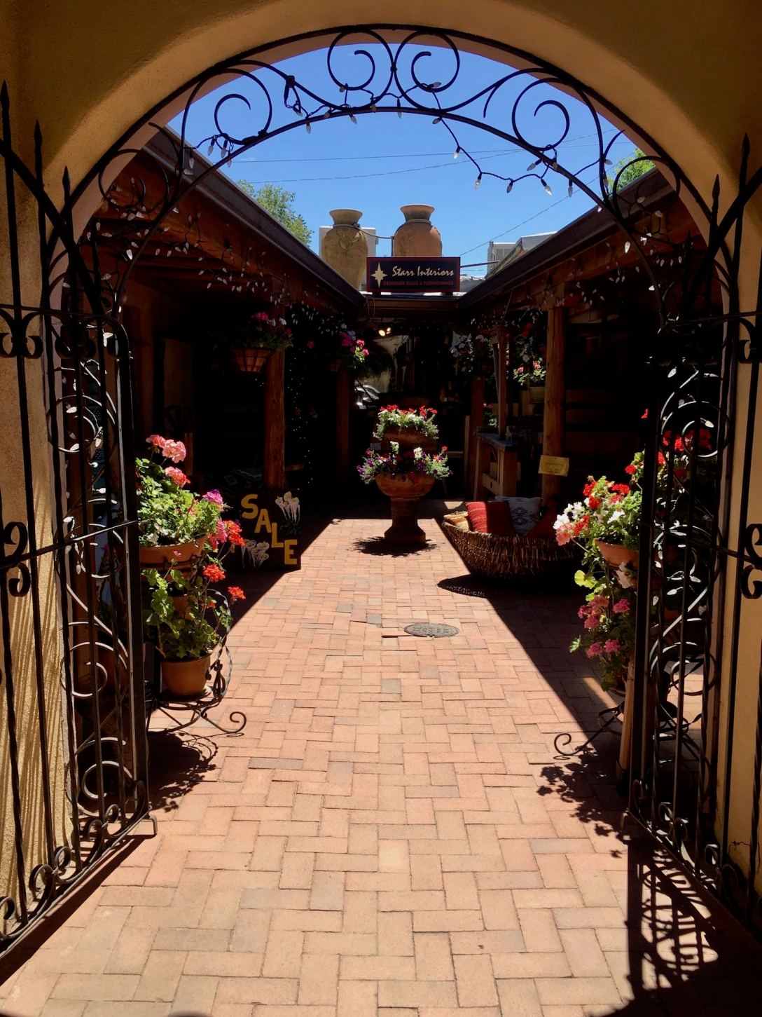 Flower pots and arch in Taos, New Mexico courtyard